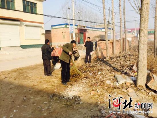 冬天和村民一起清理街道垃圾，右一為梁棟軍